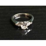 A platinum and diamond set ring, the central oval cut stone in four claw settting,