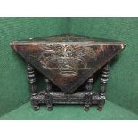 A nineteenth century heavily carved oak flap sided table