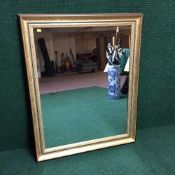 A contemporary gilt framed over mantel mirror