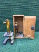 An early 20th century microscope by Watson & Sons of London in pine box