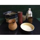 A tray of seven pieces of studio pottery - vases, shallow dish, planter,