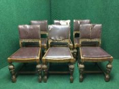 A set of six carved oak dining chairs upholstered in button leather