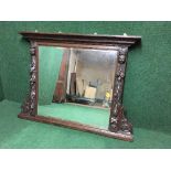 An early twentieth century heavily carved oak overmantle mirror