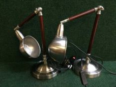 A pair of contemporary chrome angle poise lamps