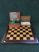 A chess board together with a set of Staunton chess pieces in mahogany box and a set of Dalmegro