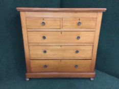 An Edwardian pine five drawer chest