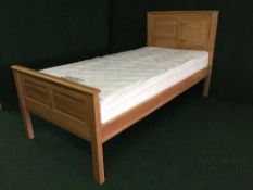 A 3' oak bed frame with mattress