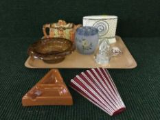 A tray of Wedgwood contrasts china mantle clock, an Arthur wood teapot, glass paperweight,