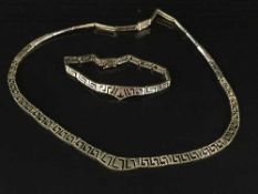 A gold necklace and bracelet set, both stamped 14K,