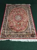 A silk finished fringed Keshan rug, 190 cm x 140 cm,