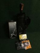 A Nike golf bag containing driver, together with a boxed Dunlop folding trolley and basket of balls,