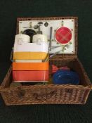 A mid twentieth century folding deck chair together with a wicker picnic basket and contents,