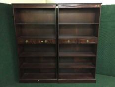 A pair of mahogany open book shelves fitted two drawers