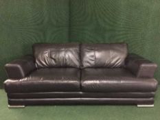 A black leather two seater settee on chrome legs