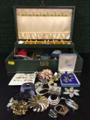 A box containing a quantity of costume jewellery including earrings and brooches etc.