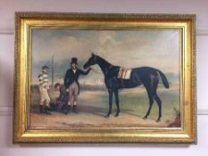 A gilt framed picture depicting a race horse