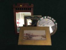 An early twentieth century mahogany framed mirror, an oval gilt framed mirror,