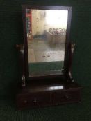 A Victorian mahogany toilet mirror fitted with two drawers