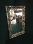 A silvered framed mirror