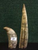 Two carved resin tusks