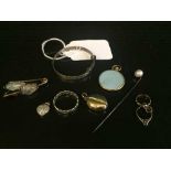 A collection of eight items of jewellery including silver baby's bangle, white metal ring,