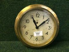 A circular brass cased Smith Sectrick wall clock
