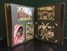 A postcard album containing assorted cards monochrome images,
