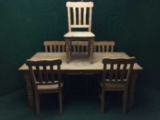 A pine farmhouse dining table fitted a drawer and six chairs