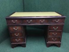 A mahogany twin pedestal leather topped desk fitted nine drawers