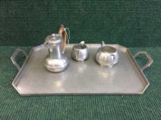 An Old English pewter twin handled tray and three piece tea service