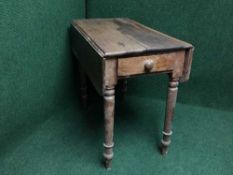 An antique pine drop leaf kitchen table fitted a drawer