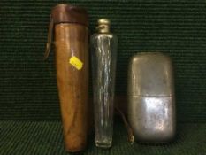 A riding flask in leather holder,