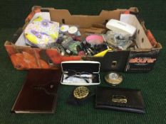 A box of pair of Versace percsription sun glasses, Cartier perfumable pen, Versace compact,