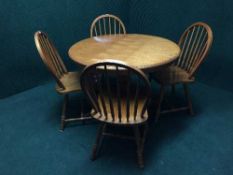 A circular pedestal table and four chairs