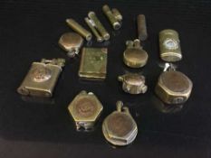 A tray of assorted copper and brass lighters