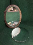 An oval framed Edwardian mirror together with a frameless mirror