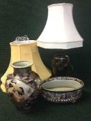 A decorative china table lamp with shade together with two extra shades and Japanese style vase