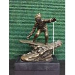 A bronze figure on marble plinth - snow boarder