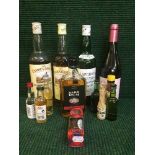 A basket of assorted bottles of Scotch whiskey, bottle of wine, bottle of rum,