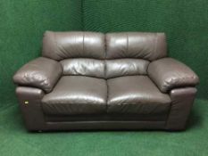 A pair of brown leather two seater settees