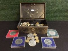A tin of assorted coins,