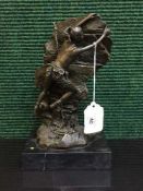 A bronze figure on marble plinth - rock climber