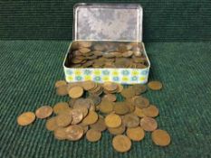 A tin of early twentieth century British pennies etc
