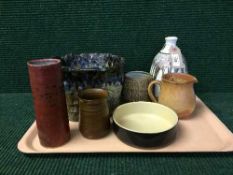 A tray of seven pieces of studio pottery - vases, shallow dish, planter,