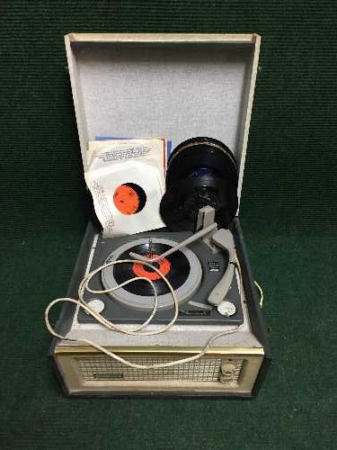 A mid 20th century Dansette Monarch table top record player and a small quantity of 45's and 78's