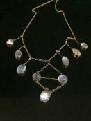A yellow metal moonstone necklace, the clasp stamped 9c.
