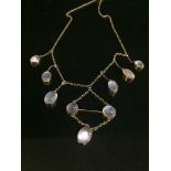 A yellow metal moonstone necklace, the clasp stamped 9c.