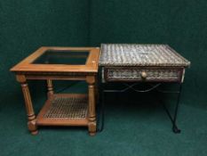 A metal and wicker side table fitted with a drawer together with a glass topped coffee table