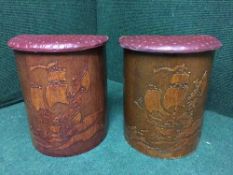A pair of oak vinyl topped storage stools depicting galleons