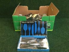 A box of stainless steel and silver plated cutlery